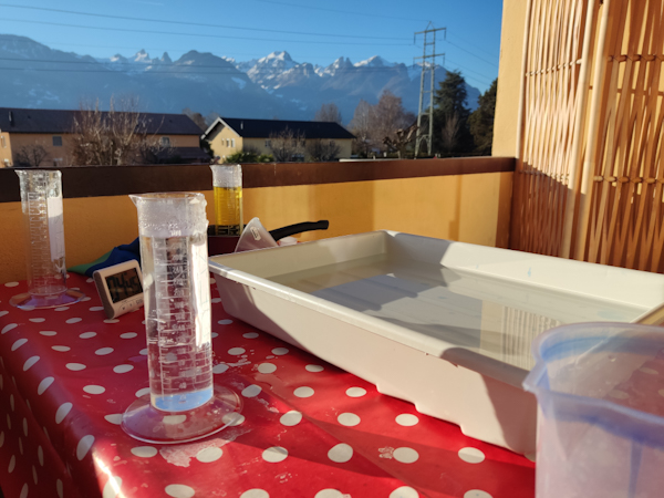 An outdoor film development lab with snow covered mountains in the background.